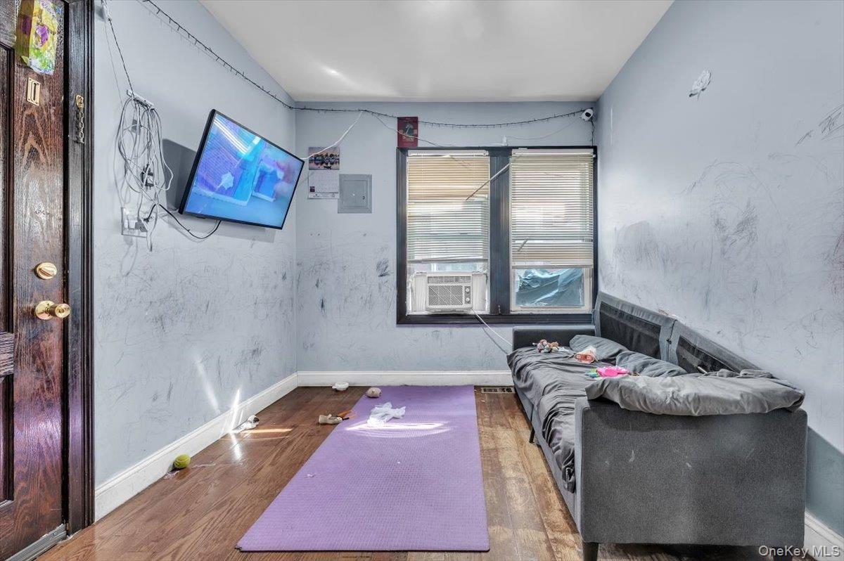 95-68 115th Street Queens, NY 11419 - Photo 11 of 28 Sitting room featuring wood finished floors and electric panel