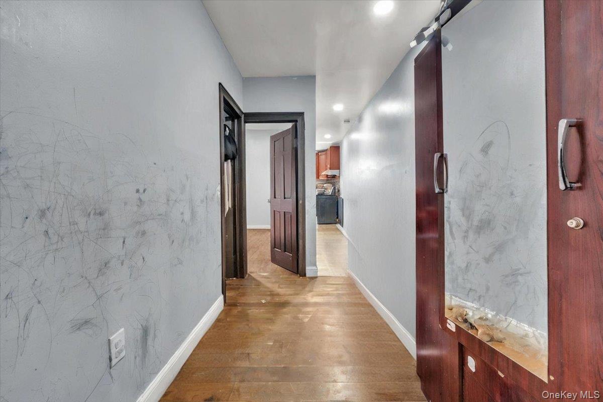 95-68 115th Street Queens, NY 11419 - Photo 13 of 28 Corridor with wood-type flooring, recessed lighting, and a barn door