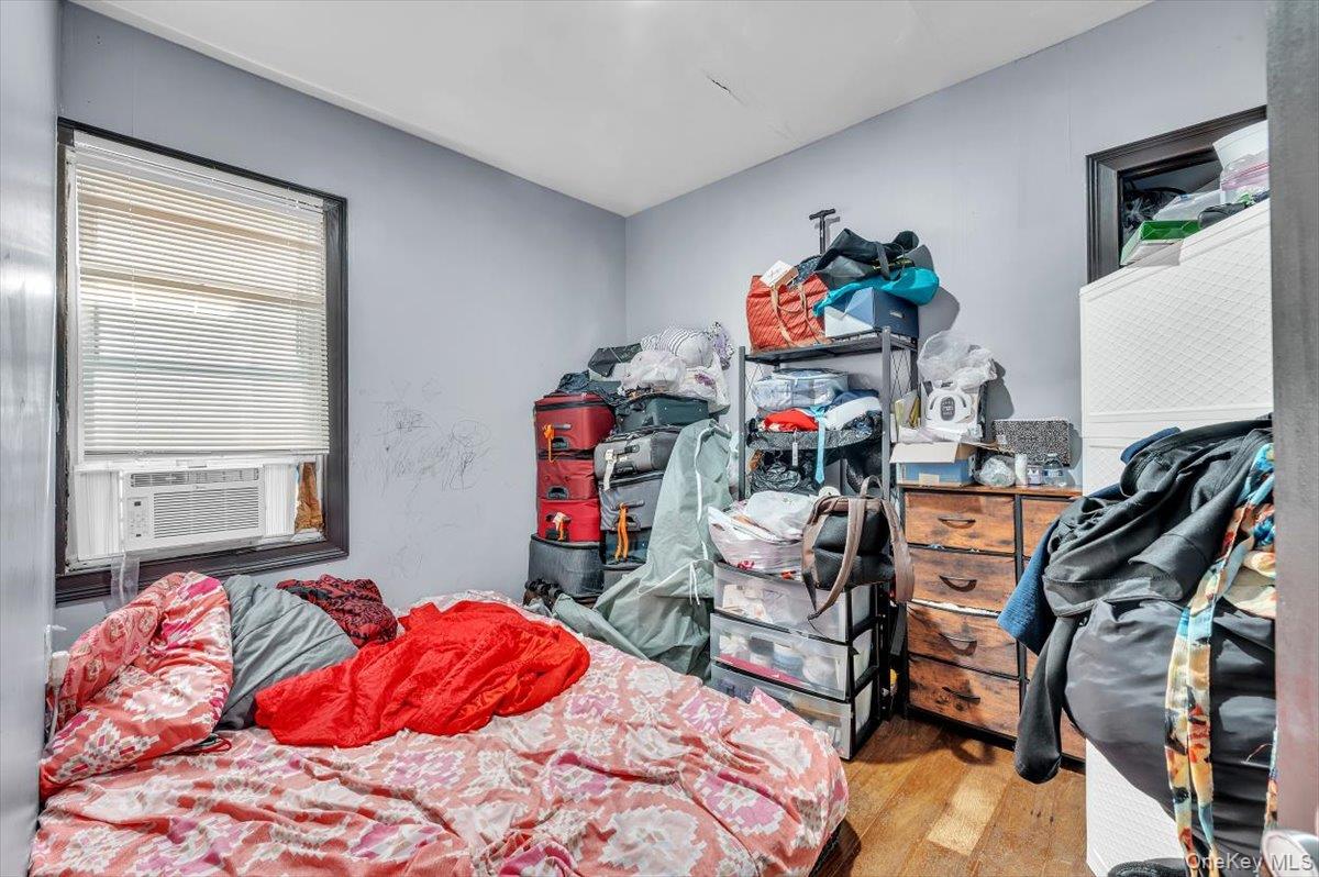 95-68 115th Street Queens, NY 11419 - Photo 14 of 28 Bedroom with light wood-style floors and cooling unit
