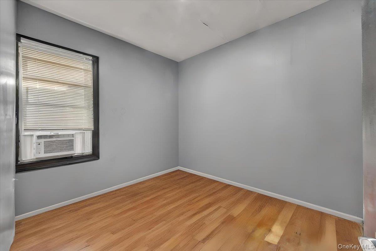 95-68 115th Street Queens, NY 11419 - Photo 15 of 28 Unfurnished room featuring wood finished floors and cooling unit