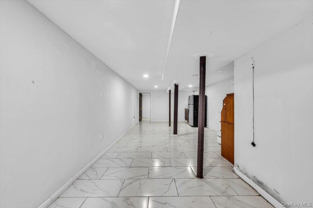 95-68 115th Street Queens, NY 11419 - Photo 20 of 28 Hallway with light marble finish flooring and recessed lighting