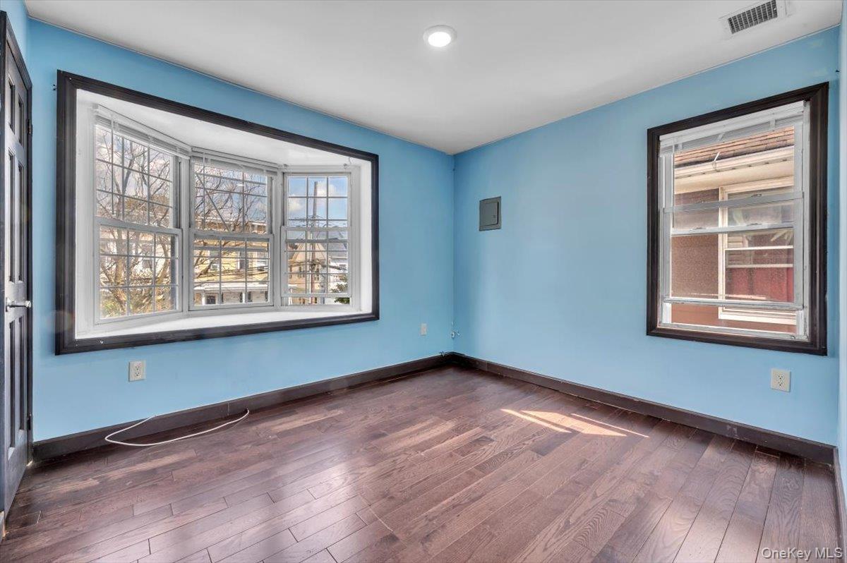 95-68 115th Street Queens, NY 11419 - Photo 5 of 28 Unfurnished room with dark wood-style floors and plenty of natural light