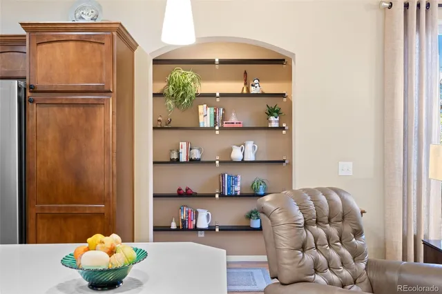 a bedroom with a bed and a shelf with wooden floor