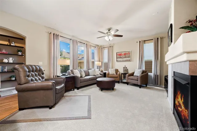 a living room with furniture fireplace and a large window