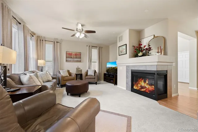 a living room with furniture and a fireplace