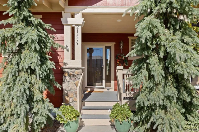 an entrance to house with yard and green space
