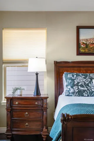 a bed room with a bed and a night stand