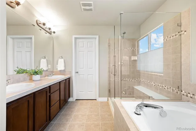 a bathroom with a tub sink and mirror