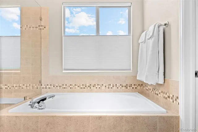 a bathroom with bathtub and window