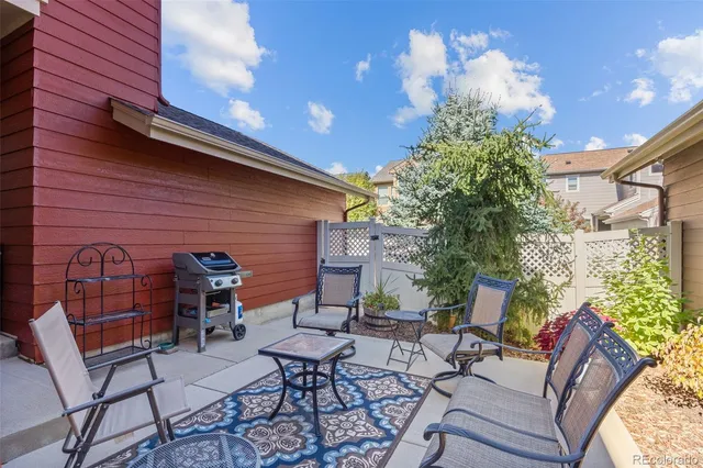 a backyard of a house with table and chairs
