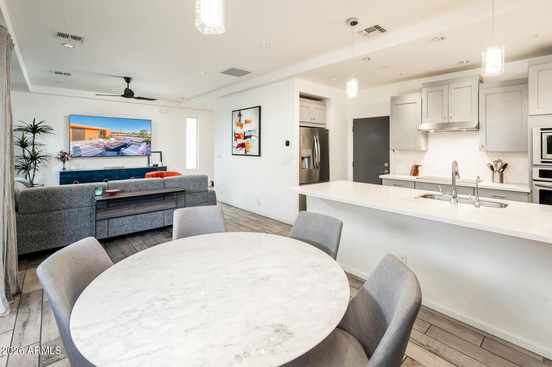4416 North 27th Way Phoenix, AZ 85016 - Photo 13 of 46 a living room with furniture kitchen view and a flat screen tv