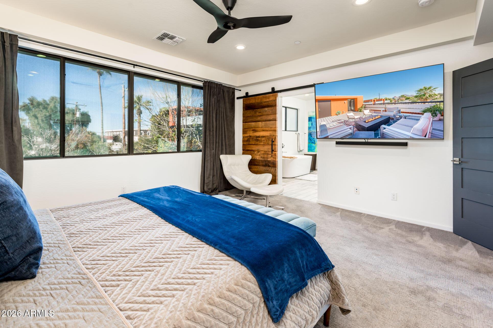 4416 North 27th Way Phoenix, AZ 85016 - Photo 21 of 46 a bedroom with a large bed and a large window