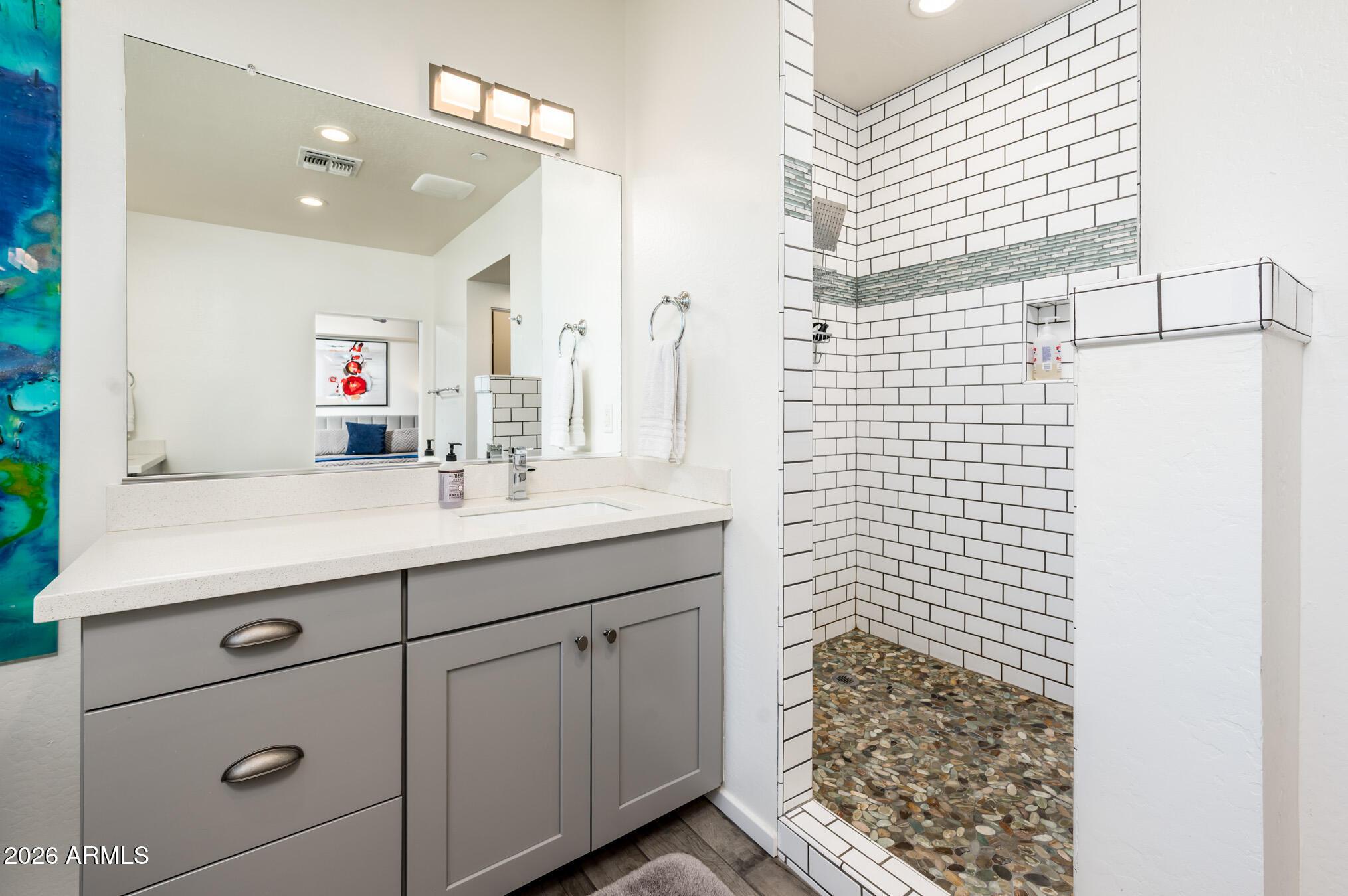 4416 North 27th Way Phoenix, AZ 85016 - Photo 23 of 46 a bathroom with a sink a shower and a mirror