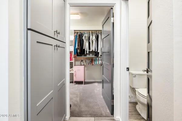 a view of walk in closet with clothes and shoes