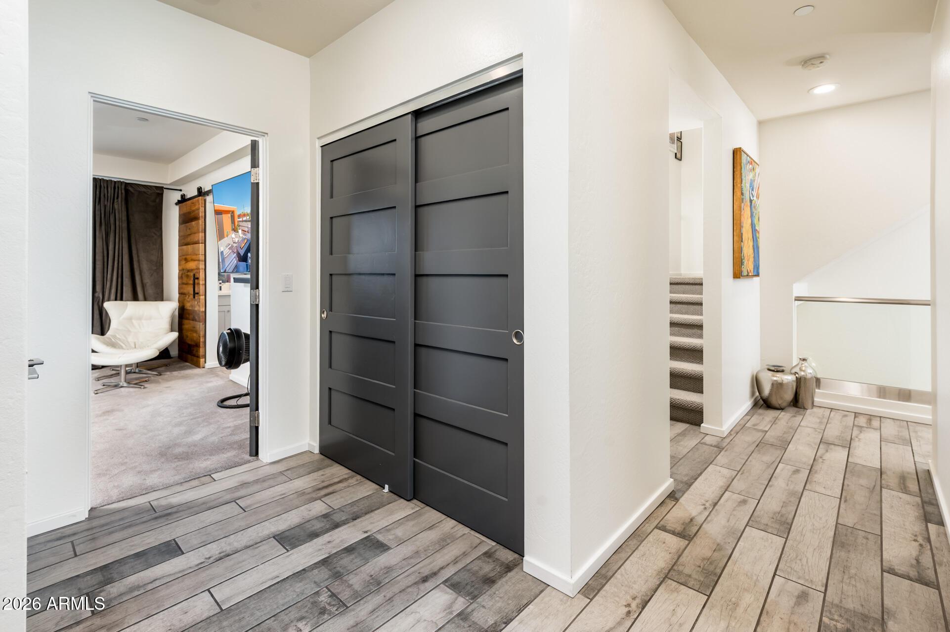 4416 North 27th Way Phoenix, AZ 85016 - Photo 33 of 46 a view of a bedroom with wooden floor and closet