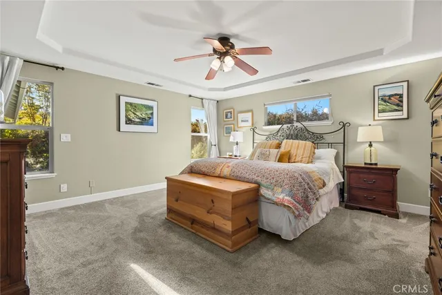 a spacious bedroom with a bed and a chandelier