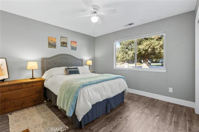 a bedroom with a large bed and a window