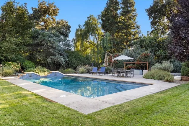 a view of a swimming pool with a table and chairs