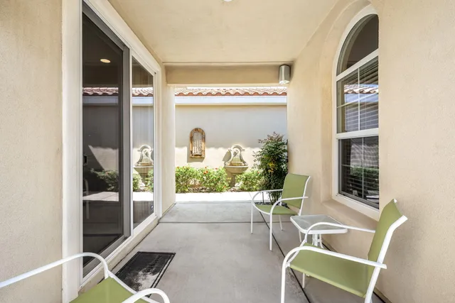 a front view of a house with a garden and trees