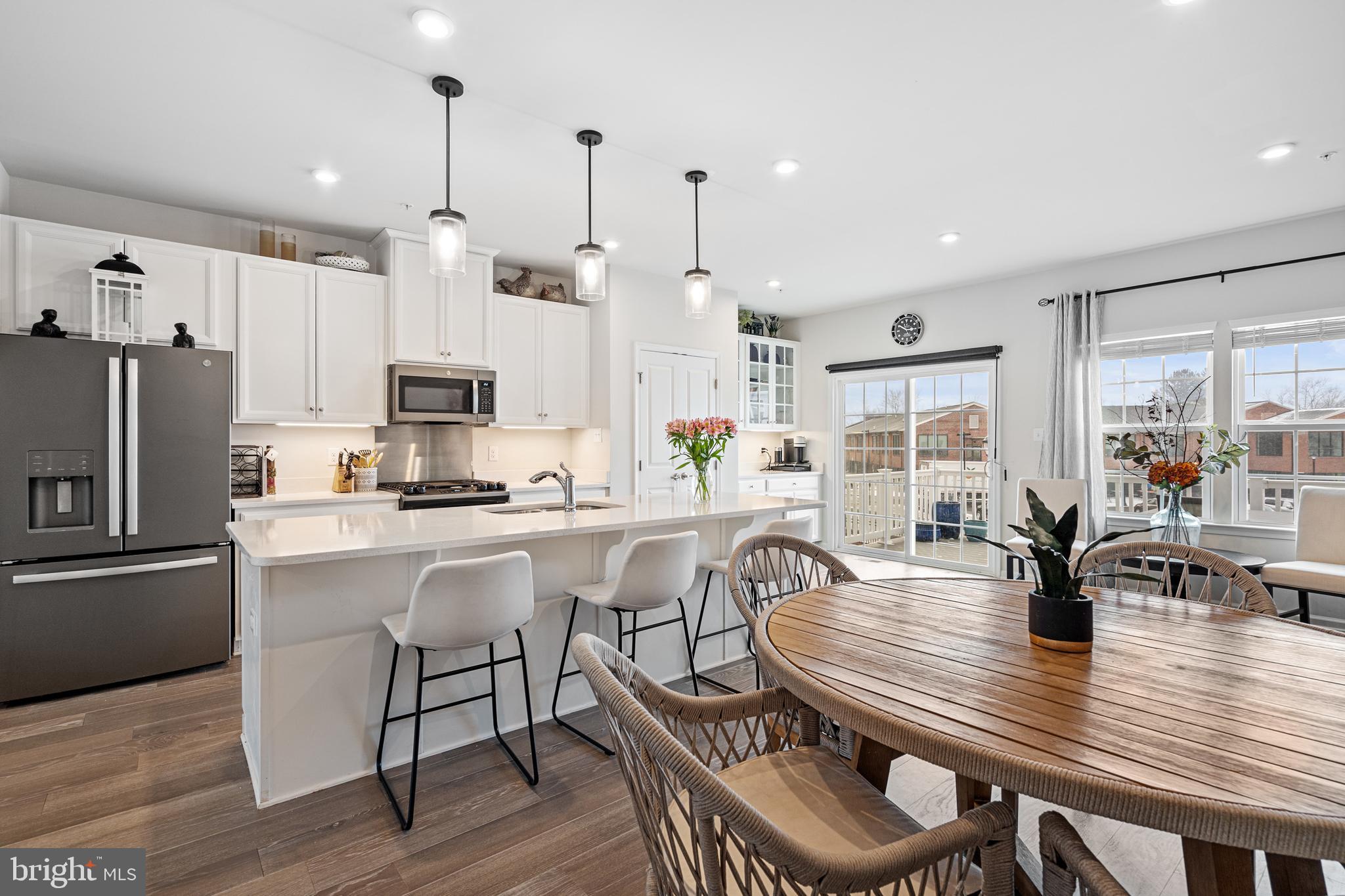 120 Bishop Way Dublin, PA 18917 - Photo 4 of 31 a kitchen with stainless steel appliances granite countertop a dining table chairs refrigerator and sink