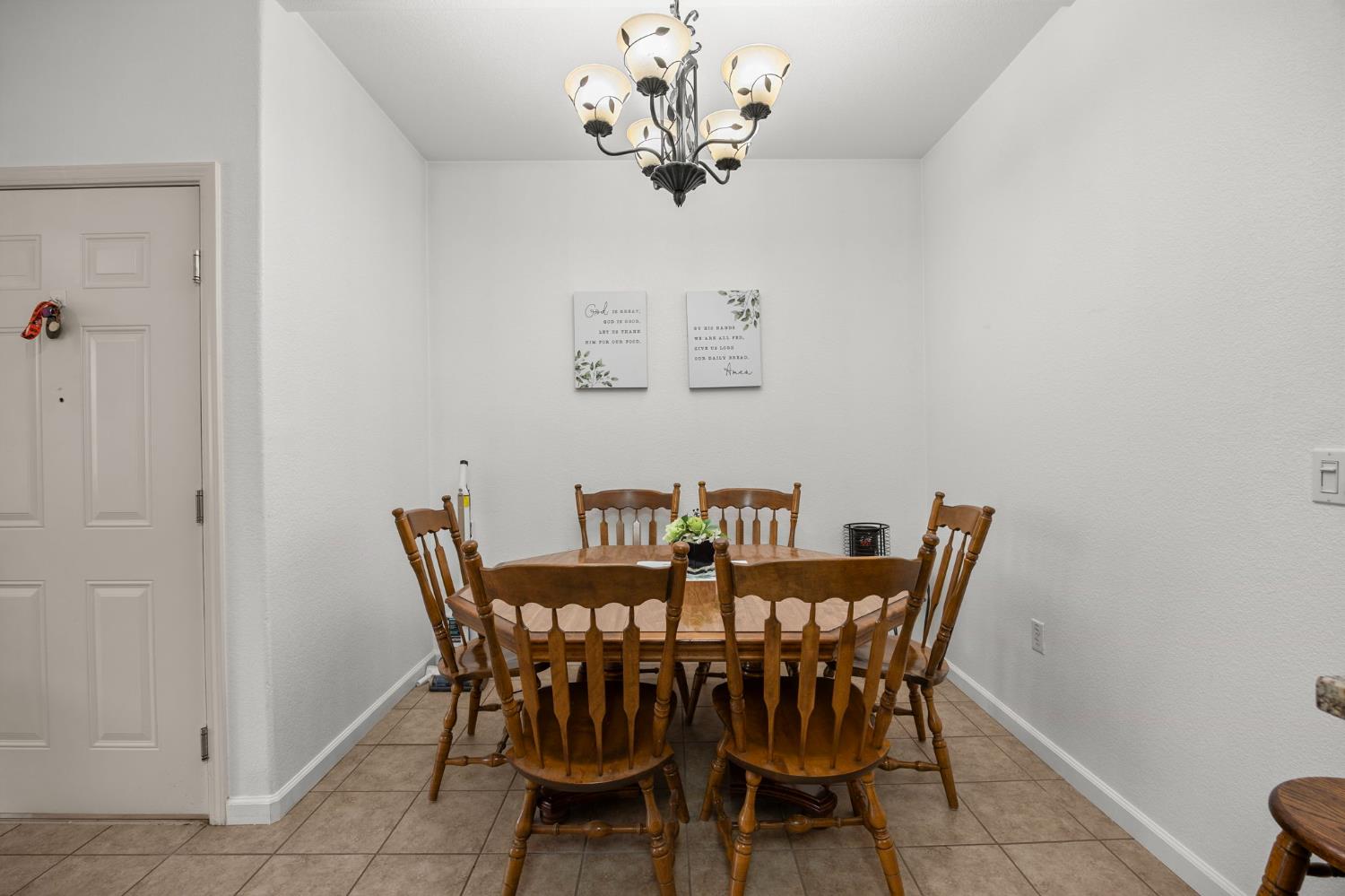 1251 Whitney Ranch Parkway, Unit 1212 Rocklin, CA 95765 - Photo 12 of 30 a view of a dining room with furniture and a chandelier