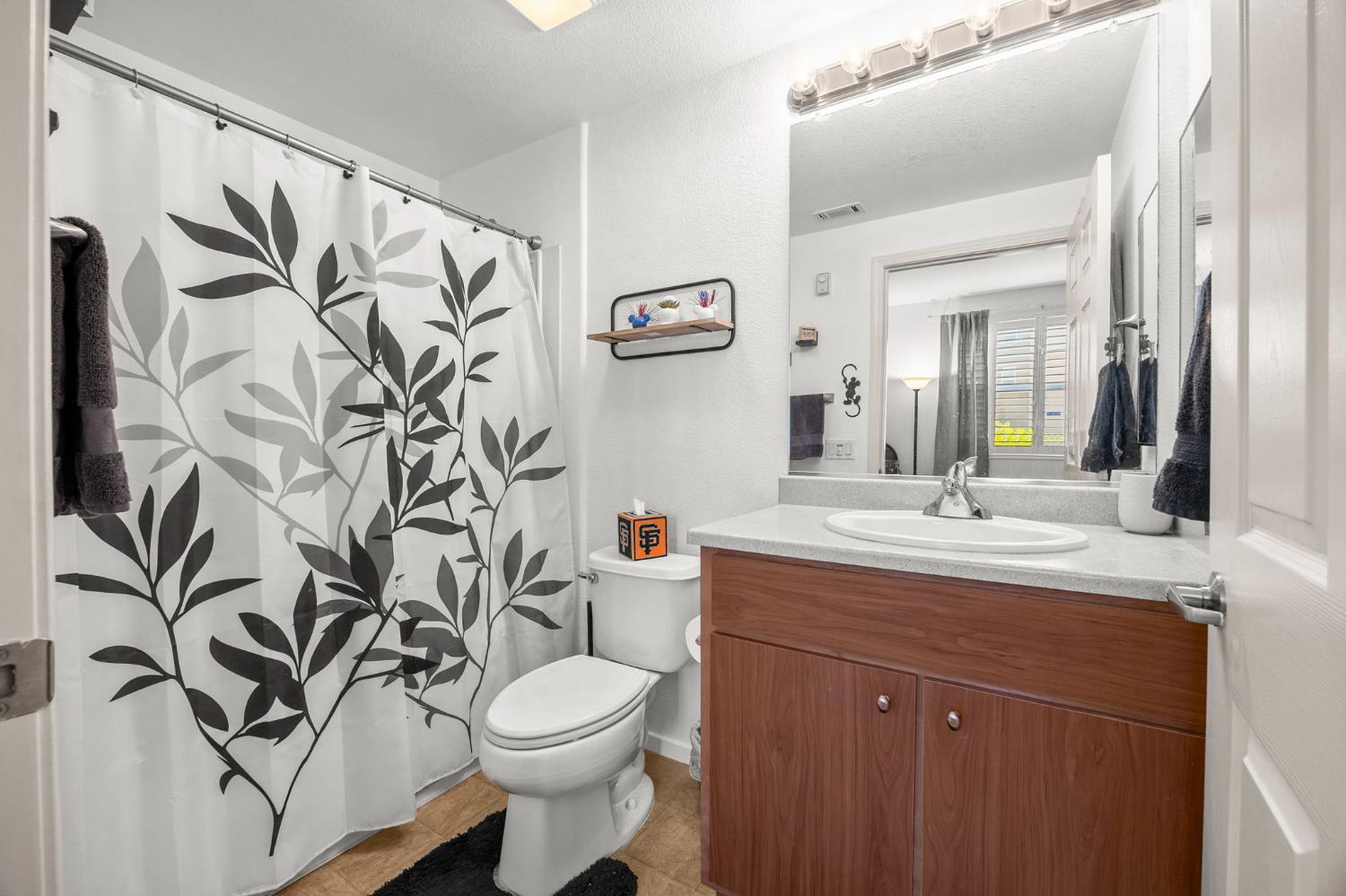 1251 Whitney Ranch Parkway, Unit 1212 Rocklin, CA 95765 - Photo 14 of 30 a bathroom with a toilet sink and mirror