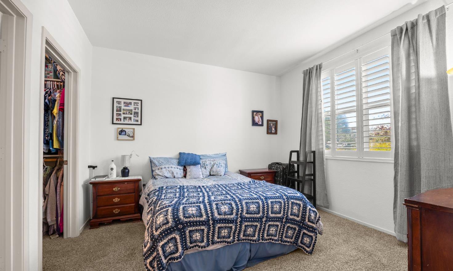 1251 Whitney Ranch Parkway, Unit 1212 Rocklin, CA 95765 - Photo 16 of 30 a bedroom with a bed and wooden floor