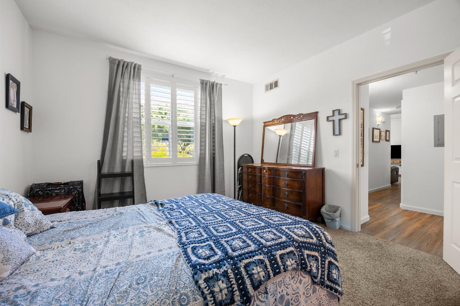 1251 Whitney Ranch Parkway, Unit 1212 Rocklin, CA 95765 - Photo 17 of 30 a bedroom with a bed and a dresser with mirror