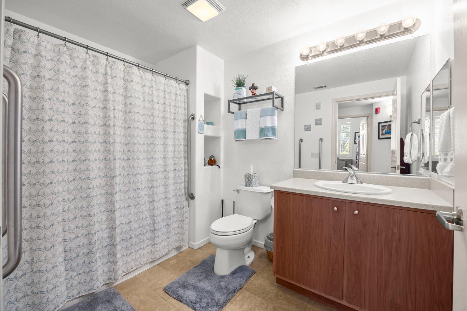 1251 Whitney Ranch Parkway, Unit 1212 Rocklin, CA 95765 - Photo 18 of 30 a spacious bathroom with a granite countertop sink a toilet and a mirror