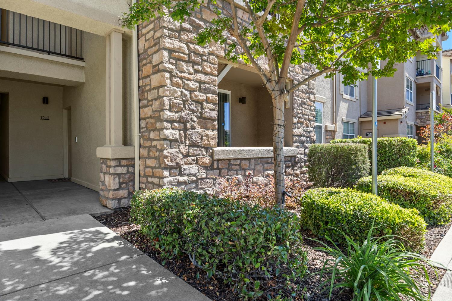 1251 Whitney Ranch Parkway, Unit 1212 Rocklin, CA 95765 - Photo 2 of 30 a front view of a house with garden
