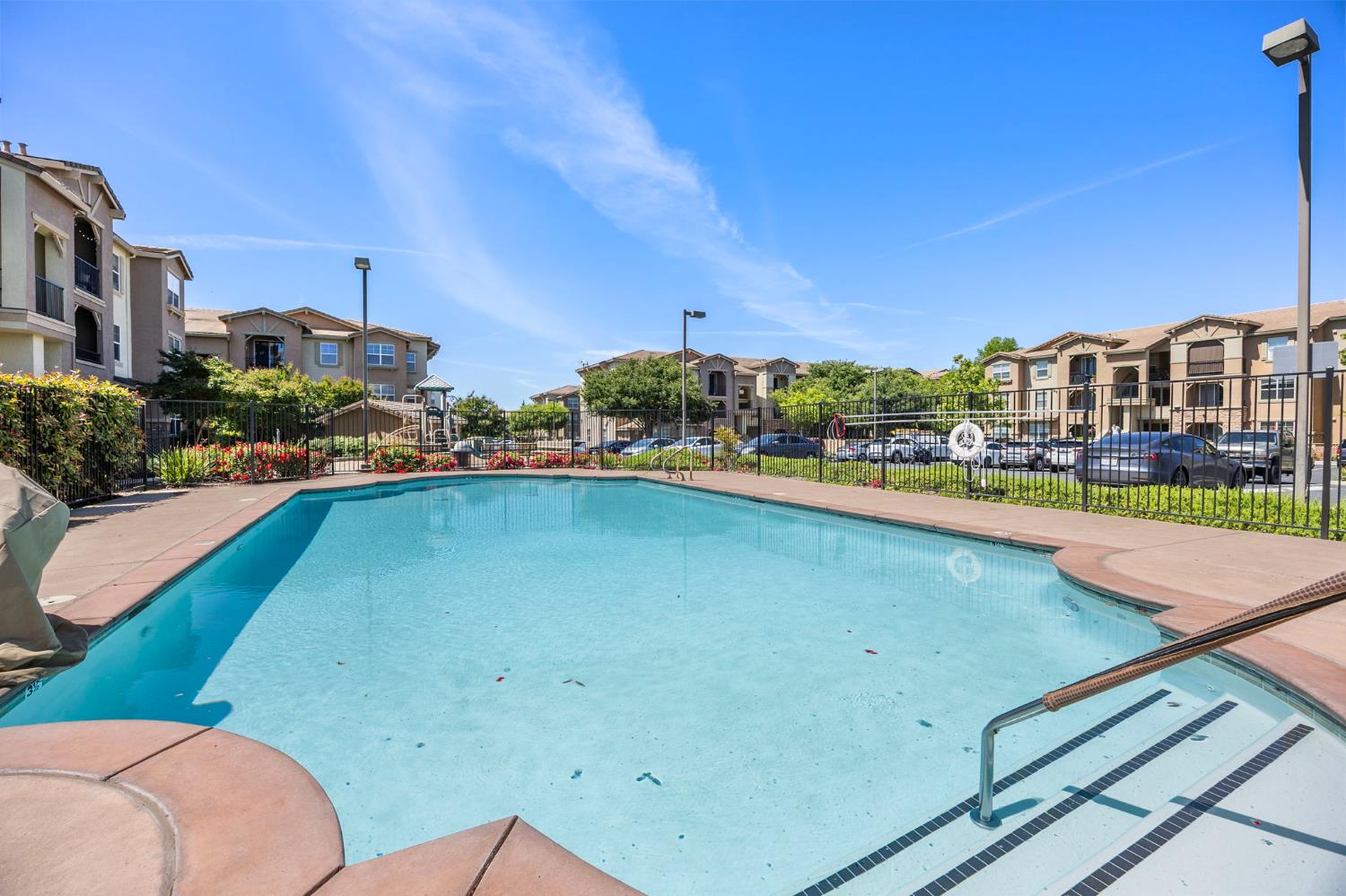 1251 Whitney Ranch Parkway, Unit 1212 Rocklin, CA 95765 - Photo 22 of 30 a view of a swimming pool with lawn chairs under an umbrella