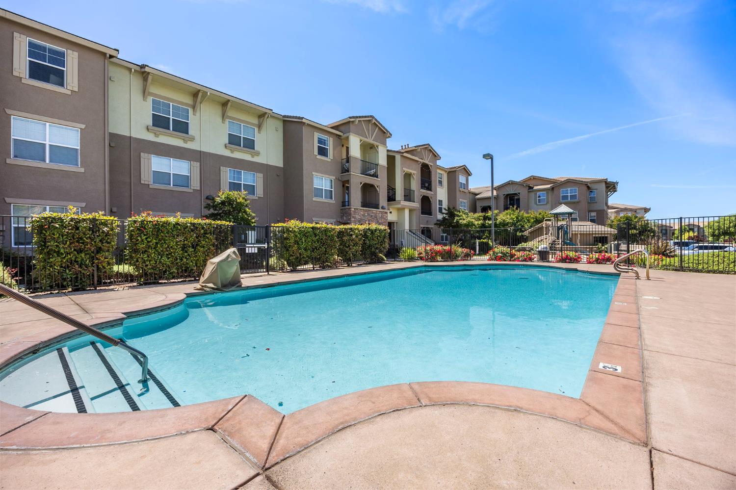 1251 Whitney Ranch Parkway, Unit 1212 Rocklin, CA 95765 - Photo 23 of 30 a front view of a house with a garden and lake view