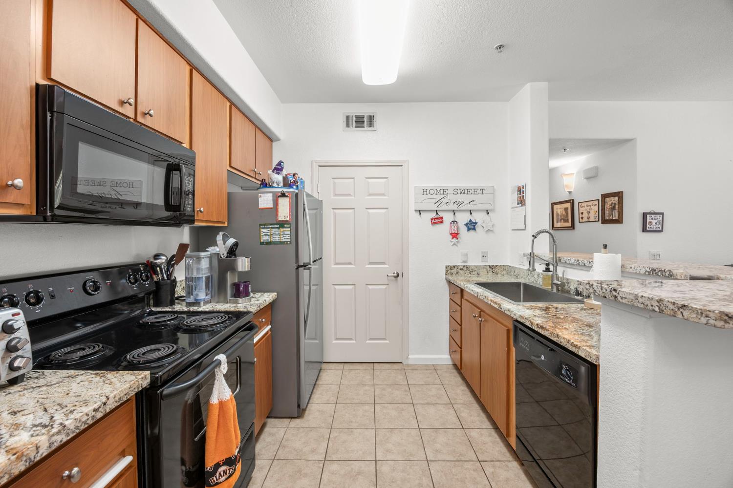 1251 Whitney Ranch Parkway, Unit 1212 Rocklin, CA 95765 - Photo 8 of 30 a kitchen with a sink stove and refrigerator
