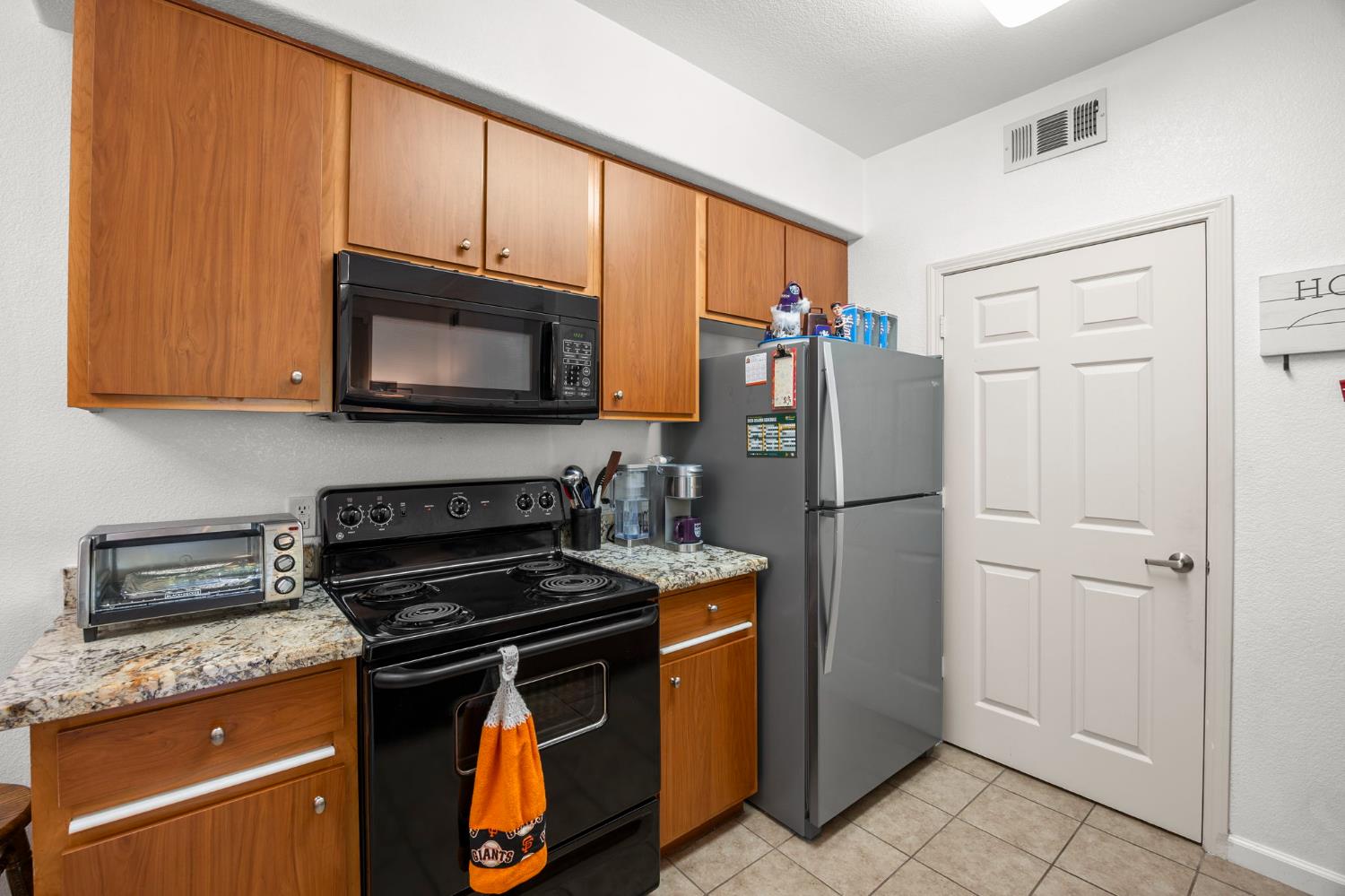 1251 Whitney Ranch Parkway, Unit 1212 Rocklin, CA 95765 - Photo 9 of 30 a kitchen with stainless steel appliances granite countertop a refrigerator stove and microwave