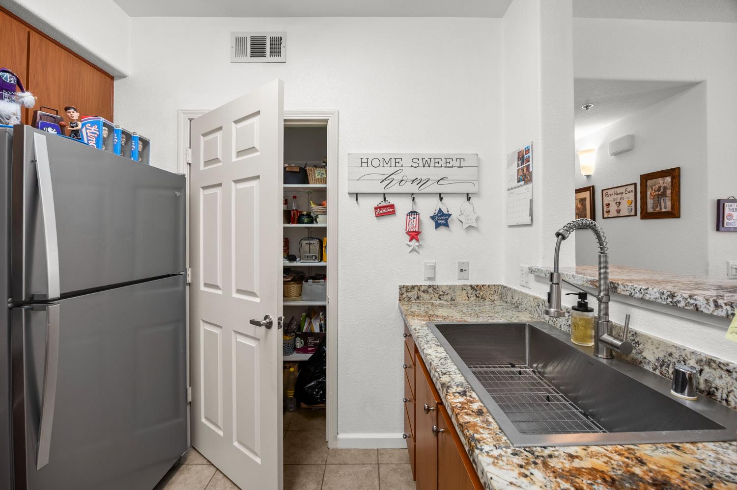 1251 Whitney Ranch Parkway, Unit 1212 Rocklin, CA 95765 - Photo 10 of 30 a kitchen with stainless steel appliances granite countertop a refrigerator and a sink