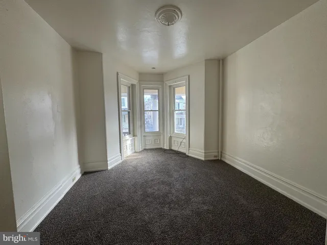 an empty room with windows and entrance