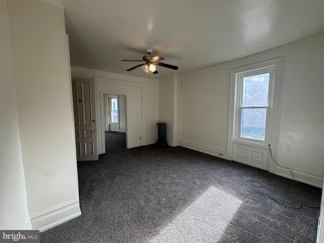 a view of a big room with closet and windows