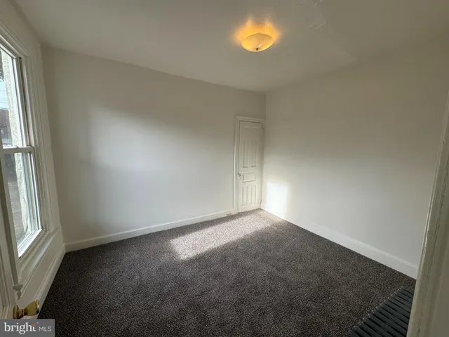 a bathroom with a tub sink vanity and mirror