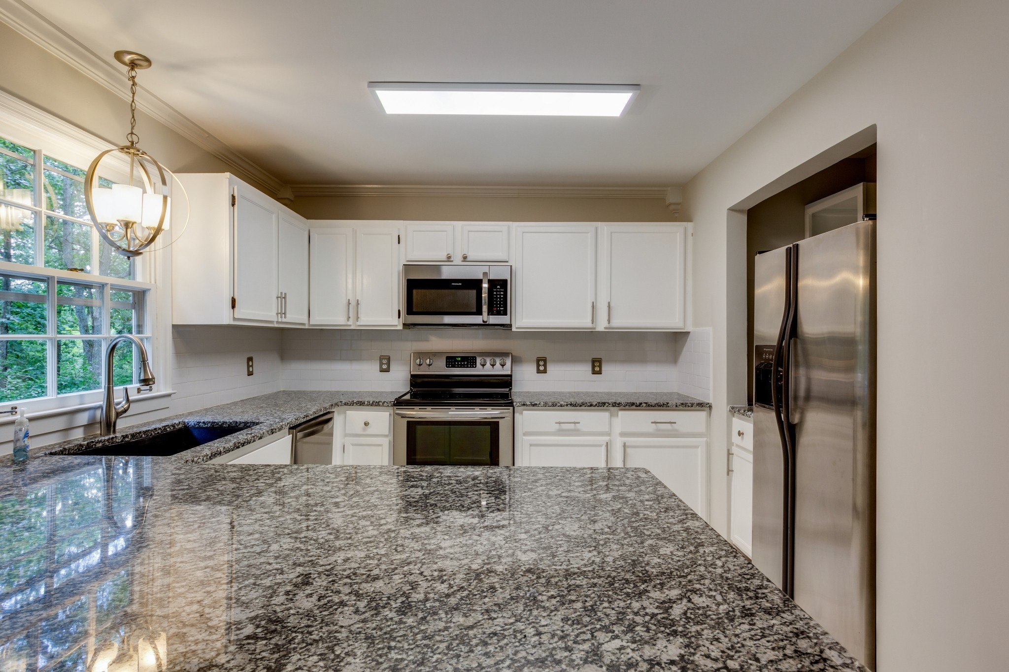 2315 Rader Ridge Road Antioch, TN 37013 - Photo 10 of 29 a kitchen with stainless steel appliances granite countertop a refrigerator sink and stove