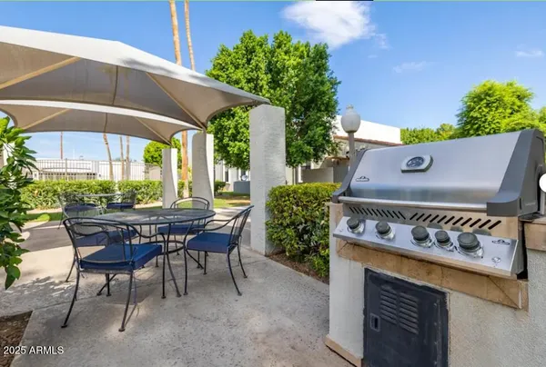 a view of a chairs and table in the backyard