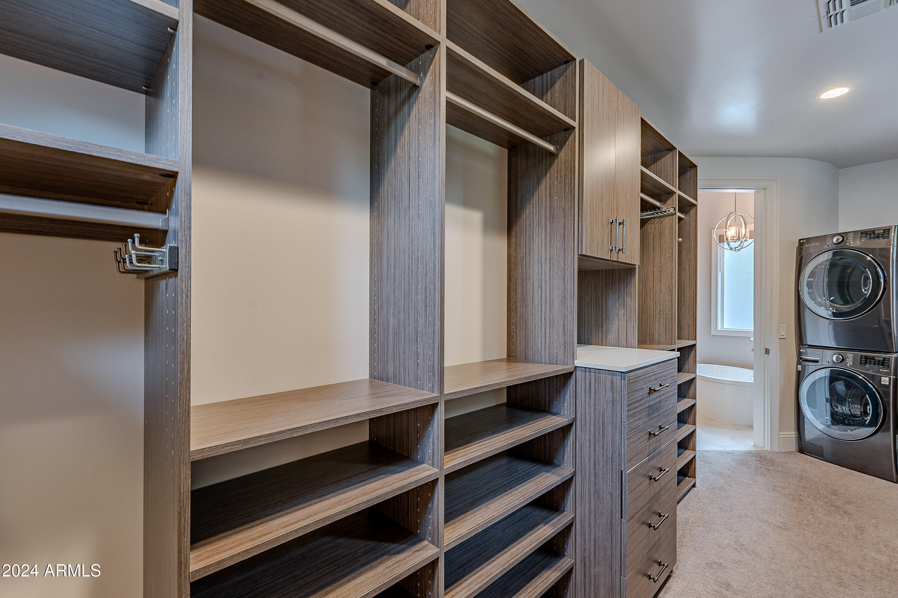 2911 East Morrison Ranch Parkway Gilbert, AZ 85296 - Photo 31 of 117 a view of walk in closet with clothes and shoes