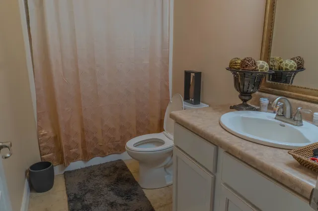 a bathroom with a sink a toilet and a mirror