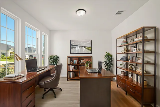 a view of a workspace with furniture and a window