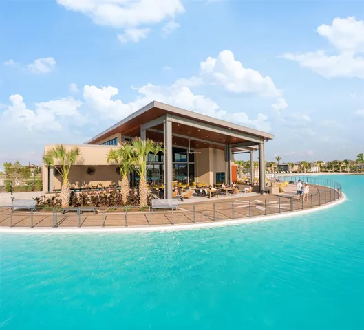 a view of a house with swimming pool and sitting area