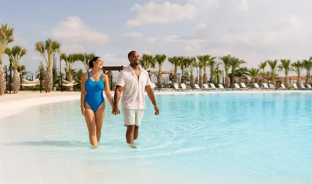 a view of a swimming pool with a yard and lake view