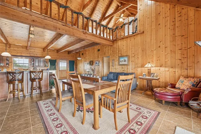 a view of a hallway with wooden floor and stairs