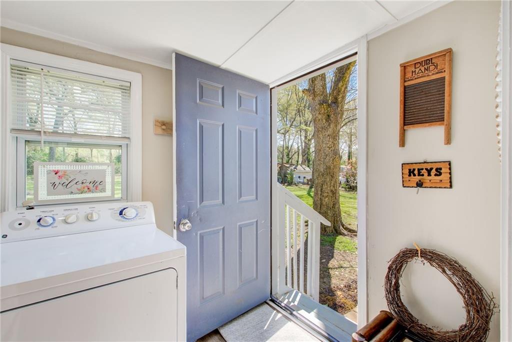 411 Ash Street Monroe, GA 30655 - Photo 10 of 36 a bathroom with a sink a toilet and a mirror