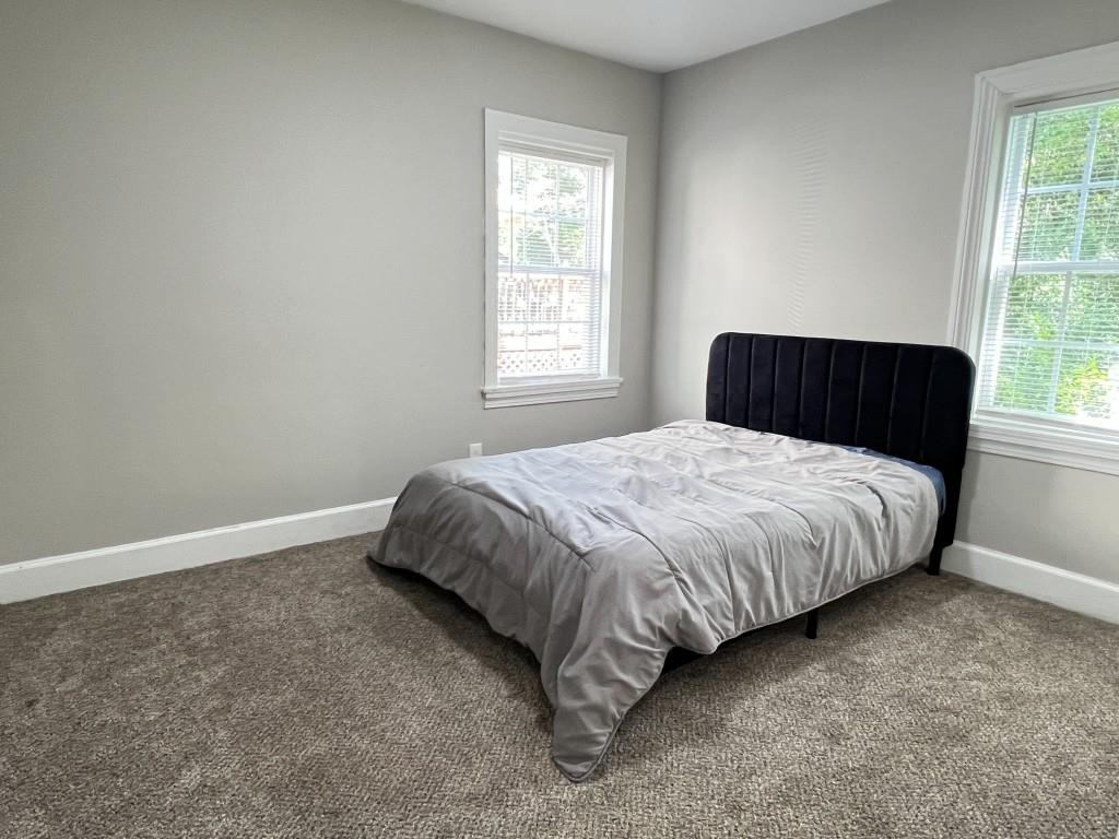 1076 Carlisle Avenue Macon, GA 31204 - Photo 12 of 16 a bed sitting in a bedroom next to a window