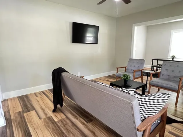 a living room with furniture and a flat screen tv