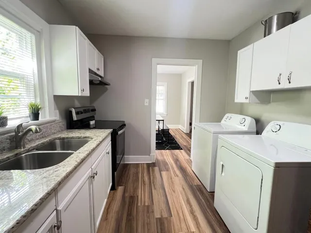 a kitchen with a stove oven and sink